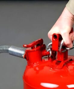 Ręka trzymająca czerwoną gaśnicę, przygotowująca ją do użycia. Gaśnica jest istotnym elementem środków awaryjnych i bezpieczeństwa pracy, chroniąc przed pożarem i wspierając ochronę środowiska.