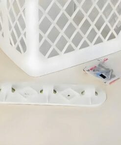 Białe koszyki z tworzywa sztucznego obok zestawu śrub i uchwytu montażowego. Koszyk ma ażurową strukturę, idealny do organizacji i przechowywania. W zestawie znajdują się również elementy montażowe, co podkreśla ich praktyczność w codziennym użytkowaniu.