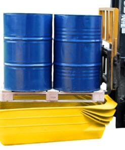 Dwa niebieskie bębny umieszczone na palecie, stojące na żółtej wannie wychwytowej, stanowiącej element systemu bezpieczeństwa pracy w kontekście ochrony środowiska. Widoczny wózek widłowy w tle.